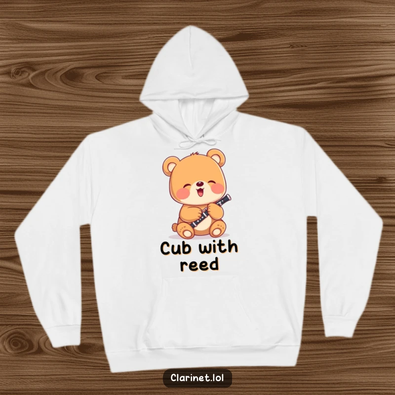 Funny bear cub happily playing a small clarinet, depicted on a warm and comfortable hoodie, a delightful humorous apparel choice.